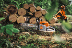 Motosega STIHL MS 300 C-M appoggiata su un tronco davanti a una catasta di legna.